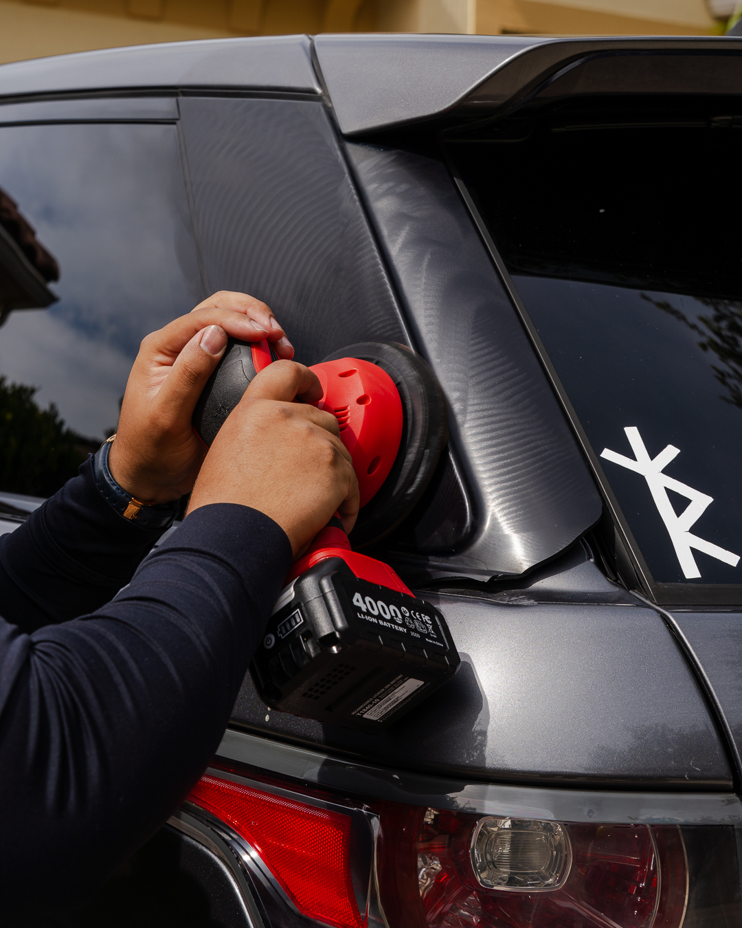 Dual-action polisher correcting paint on a Range Rover — JDM Wash mobile detail