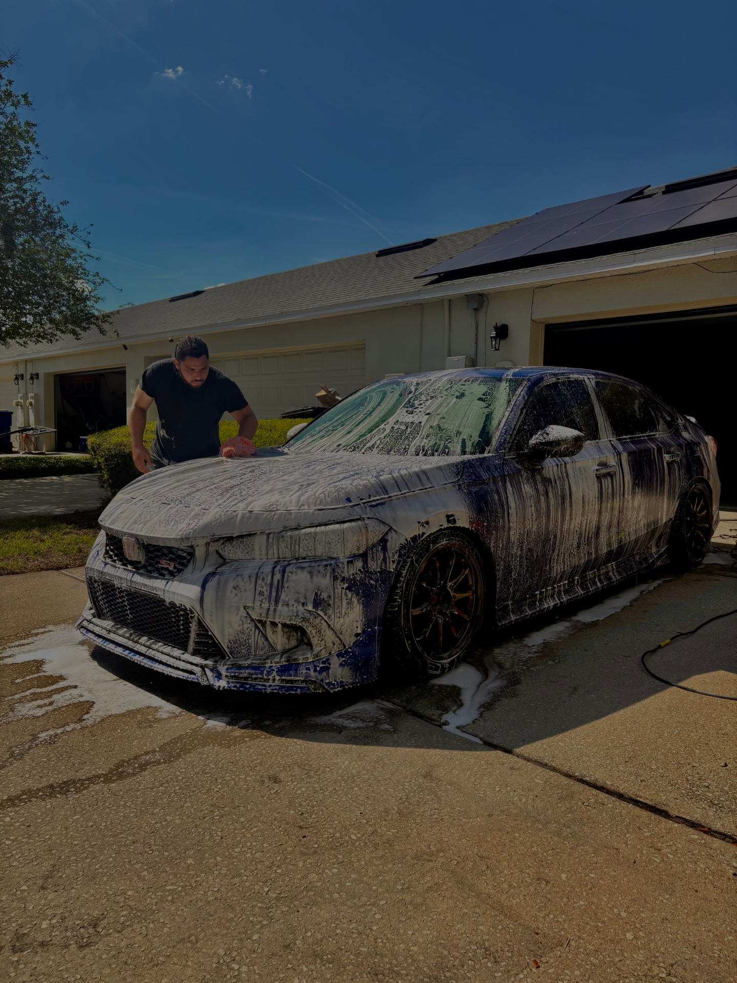 JDM Wash detailer foam-washing a blue Honda Civic Si