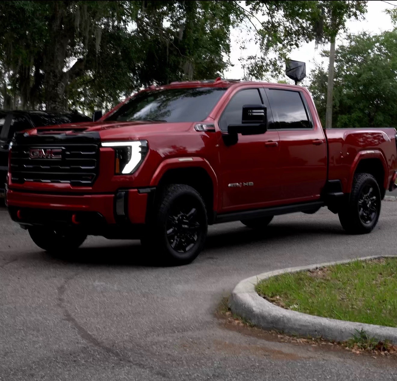 Freshly detailed dark red GMC Sierra showing deep gloss and shine