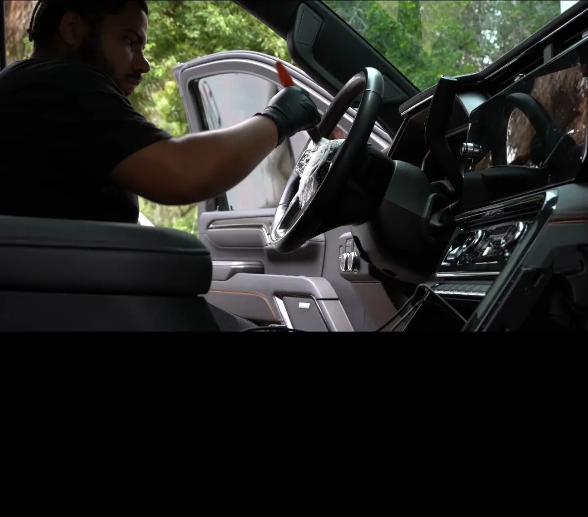 Mobile interior car detailing in Kissimmee, FL - JDM Wash detailer cleaning a steering wheel